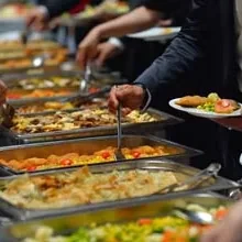 Guests serving themselves from catering trays